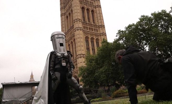 A candidate in a rubbish bin costume runs against Nigel Farage in by-election